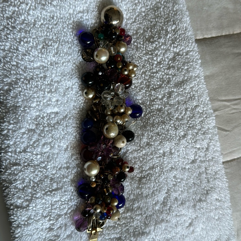 Multicolored stone bracelet- handcrafted. Yellow metal. 7 inches.